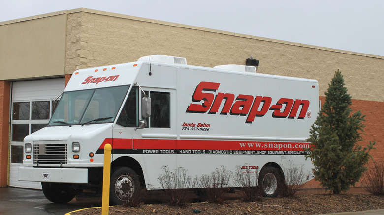 A Snap-on truck outside of a workshop building