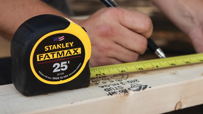 A Stanley tape measure on a piece of wood