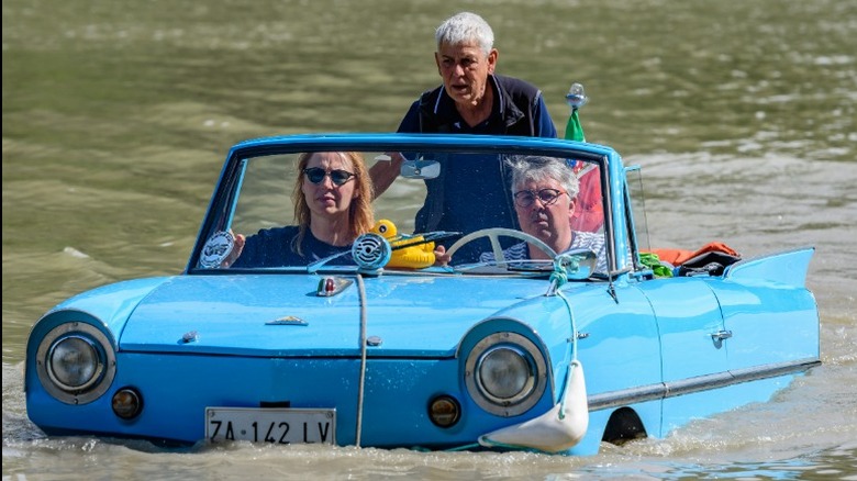 Blue Amphicar in the water with three passengers