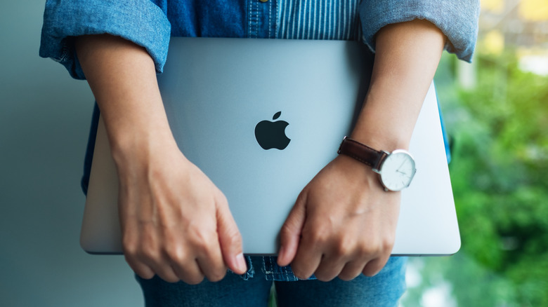 Apple Macbook in man's hands
