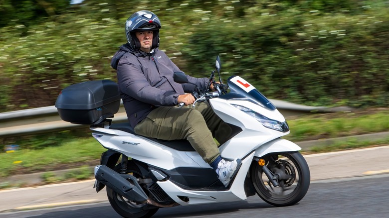 Man riding Honda PCX scooter