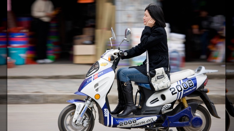 Woman riding on Chinese scooter