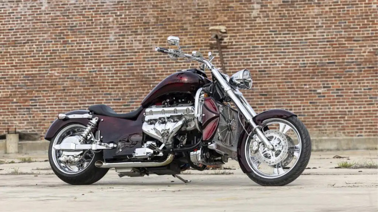 A Boss Hoss motorcycle in front of a brick wall