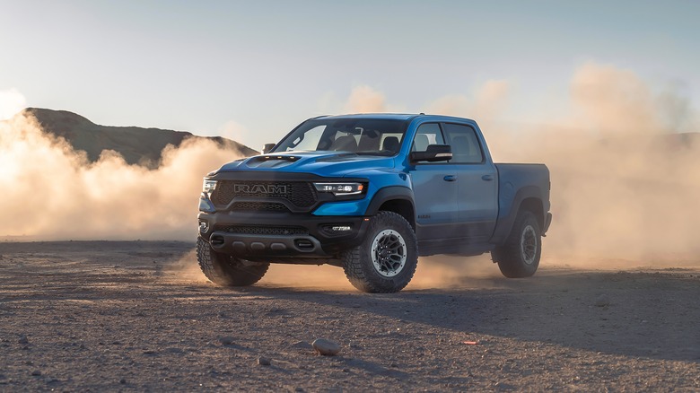 A blue Dodge Ram driving through the desert