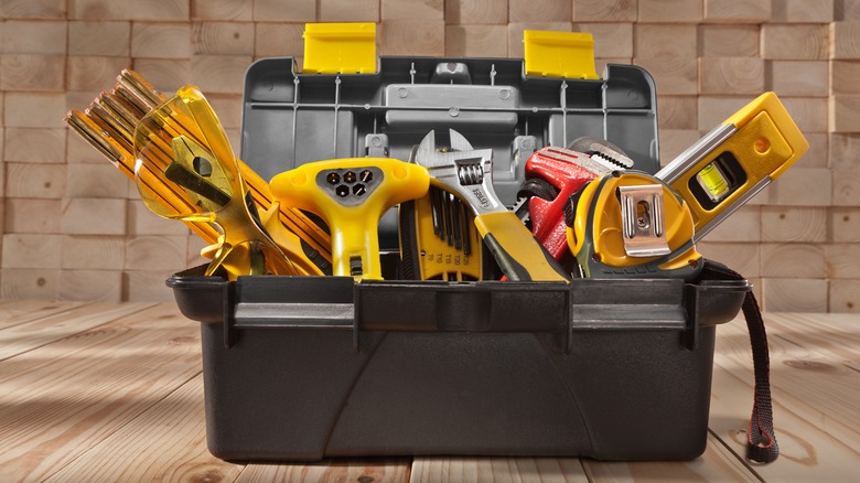 Open toolbox overstuffed with tools