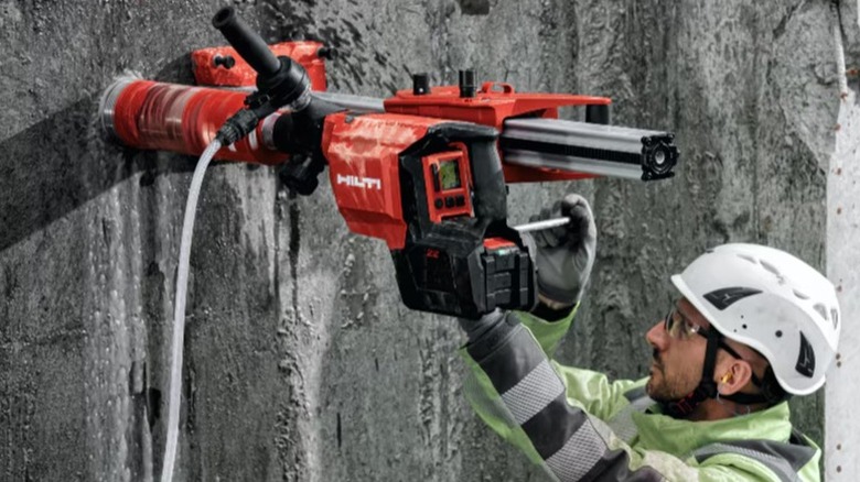 Person using Hilti tool on wall