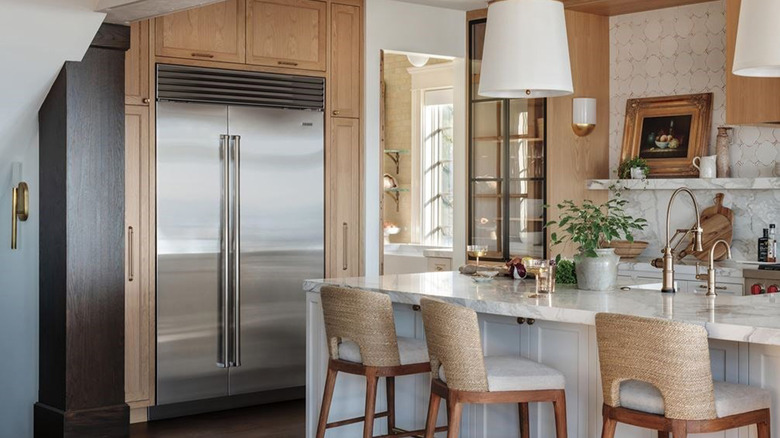 A Sub-Zero fridge in a kitchen with wood and marble
