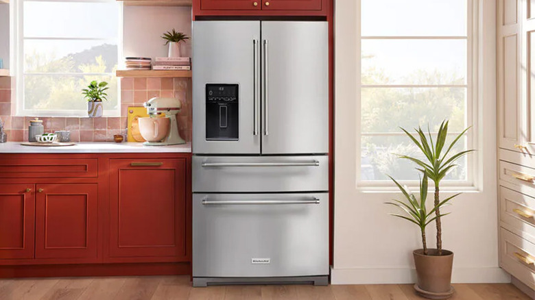 A KitchenAid fridge in a kitchen with a plant