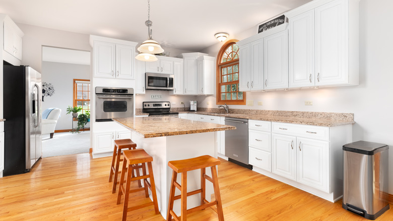 A white kitchen with stainless steel appliances