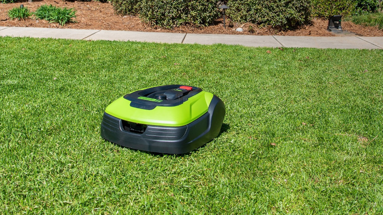 An Optimow 50H Greenworks robot mower in a lawn.