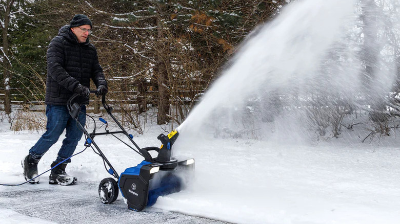 A person operating a Westinghouse snow blower