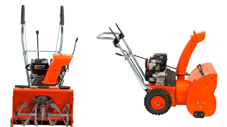 An orange Yardmax snow blower seen from the front and from the side on a white background