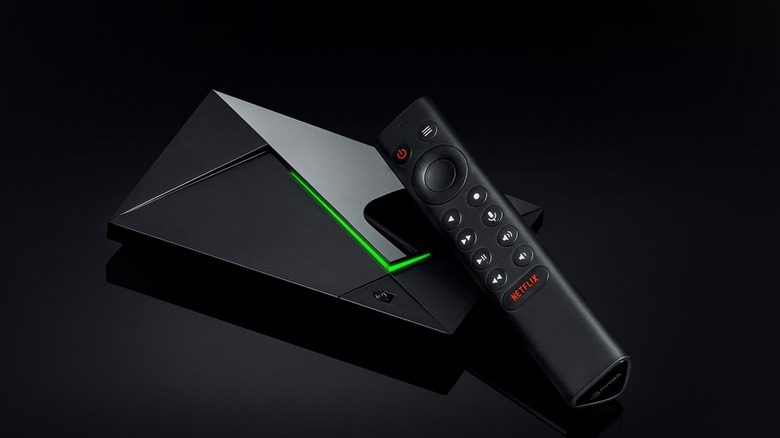 Nvidia shield tv pro and remote on black background