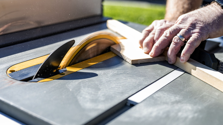 cutting a board with a table saw