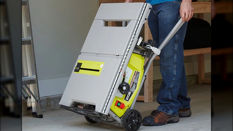 user rolling a Ryobi table saw