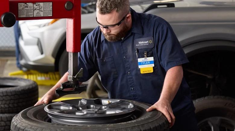 Walmart technician with a tire