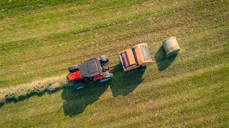 A tractor collecting dried grass