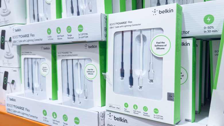 A retail shelf displays multiple Belkin USB-C cables in white and green packaging.