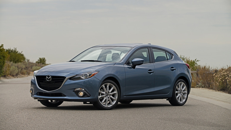 Front 3/4 view of the third generation Mazda3 in blue