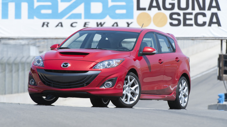 Red 2010 Mazdaspeed3 at Laguna Seca Raceway, front 3/4 view, static shot