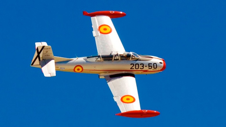 A CASA Saeta HA200 flying over blue skies