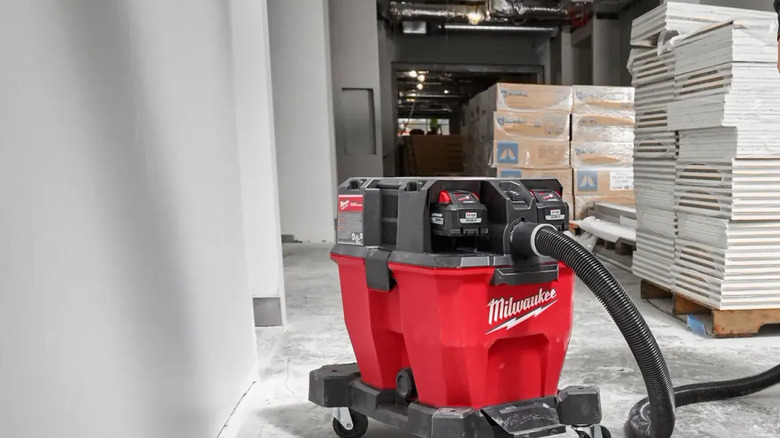 The M18 Fuel 9 Gallon Dual-Battery Wet/Dry Vacuum being used by a person off camera