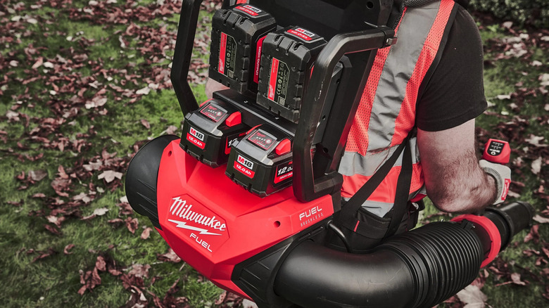 The M18 Fuel Dual-Battery Backpack Blower seen from behind, being worn by a person
