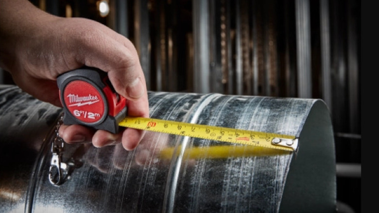 Person measuring with tape measure
