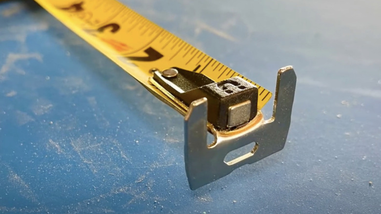 A close up of the blade of a tape measure with a magnet