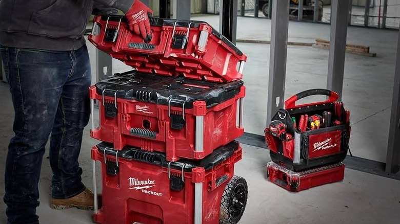 A person puts the Packout Tool Case stacked on top of other Packout products
