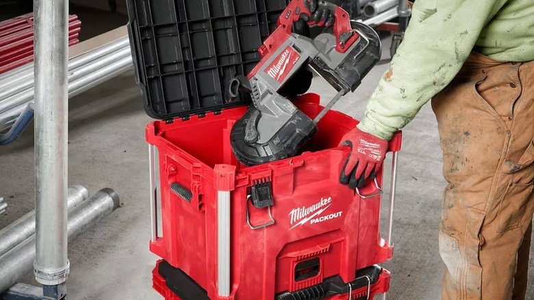 A person mostly out of frame puts a very large Milwaukee tool inside the Packout XL Tool Box
