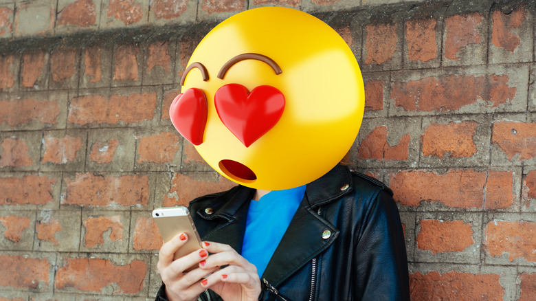 Emoji head using a phone