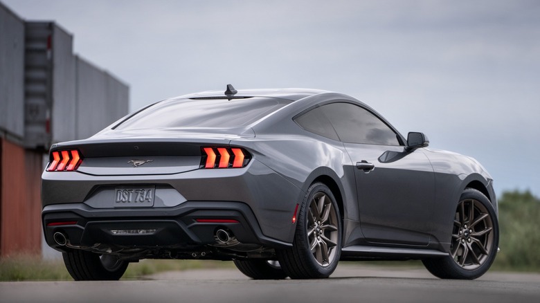 Gray current-generation Ford Mustang seen from behind right