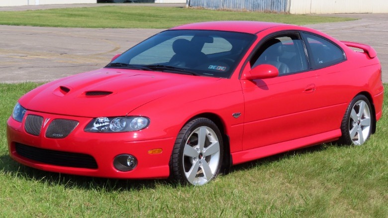 Red 2006 Pontiac GTO parked on grass