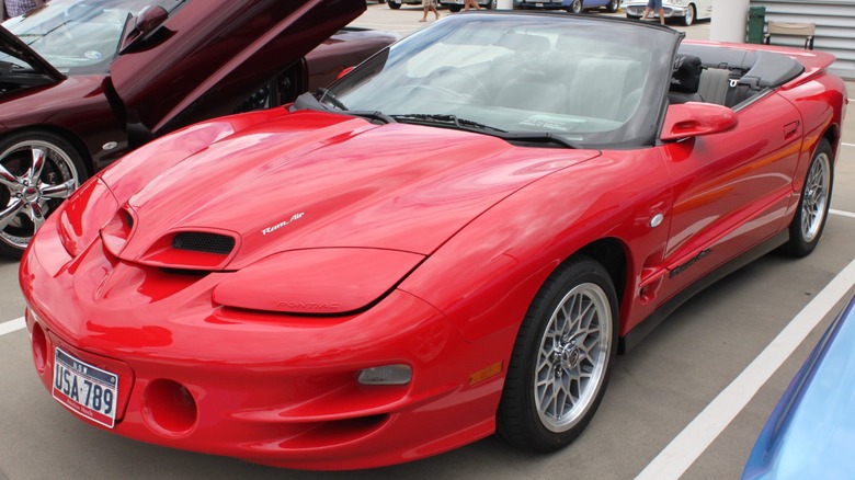 Red 2000 Pontiac Firebird Trans Am WS6 convertible parked at a car show