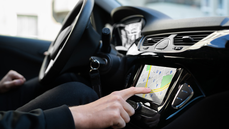 man using navigation while driving
