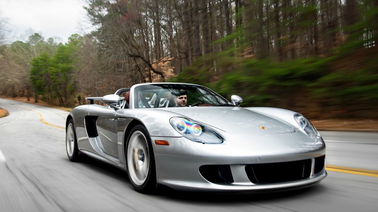 silver Porsche 911 on a mountain road