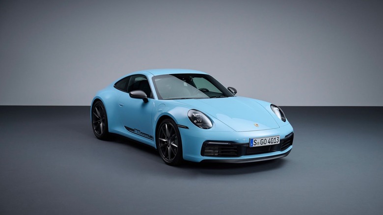 A blue Porsche 911 Carrera T from the 992.1 generation from 2022 standing in a studio.