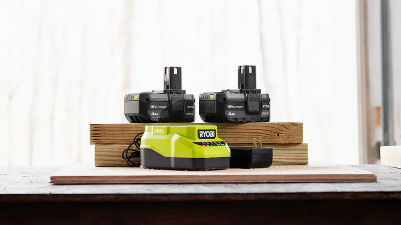 The standard Ryobi One+ Charger with batteries nearby
