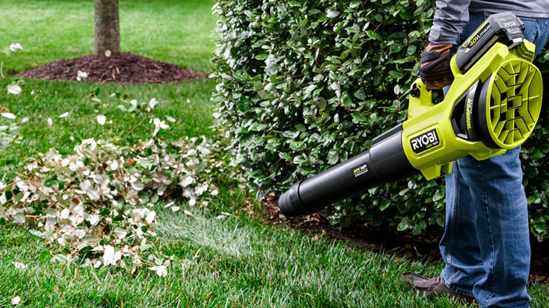 A man blowing leaves with a 730 CFM Ryobi leaf blower