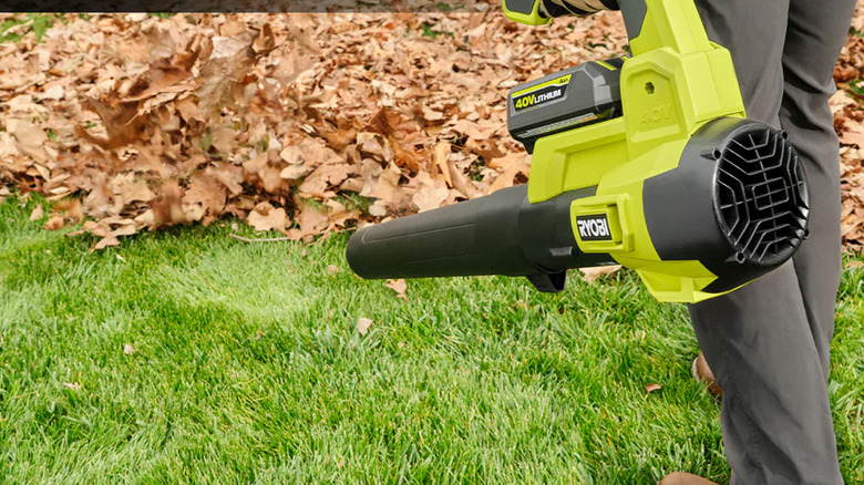 A man clearing leaves with a 40V Ryobi leaf blower