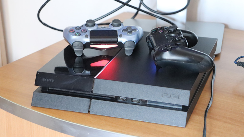 The PlayStation 4 console with two controllers placed on top of it