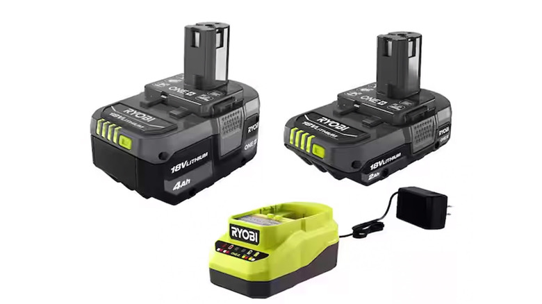 A stock image of a Ryobi charger and two batteries