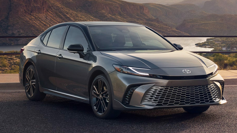 A Toyota Camry parked by a scenic landscape