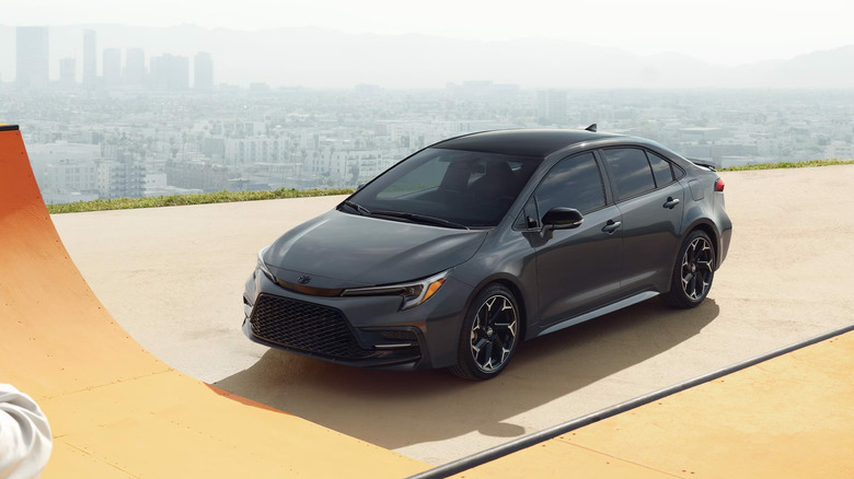 A Toyota Corolla against a cityscape background