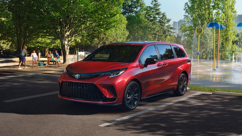 A red Toyota Sienna parked at a water park