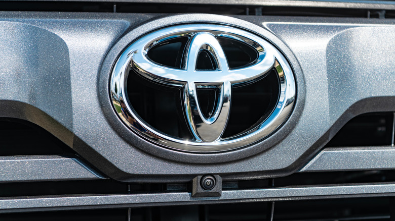 A Toyota logo on the hood of a luxury car