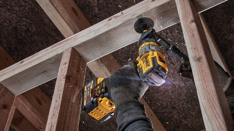 Person using DeWalt cordless hammer drill