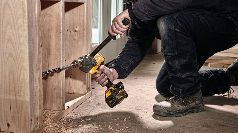 Person using DeWalt mixer drill
