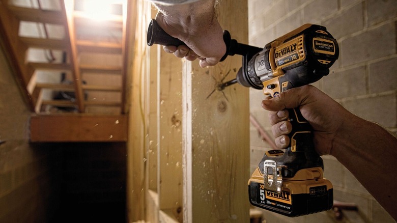 Person using DeWalt three-speed drill